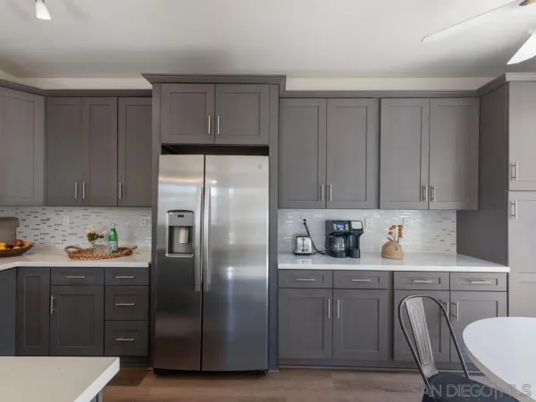 a kitchen with stainless steel appliances a refrigerator and sink