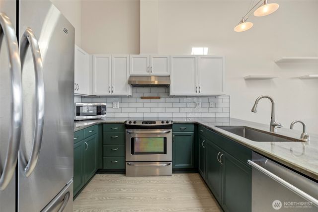 a kitchen with a sink stove and cabinets