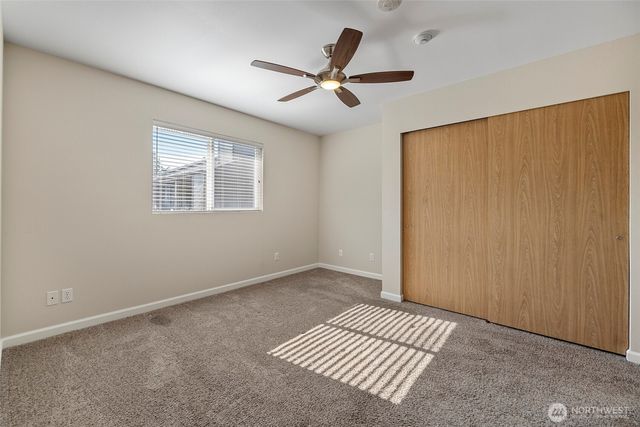 a view of a bedroom with a ceiling fan