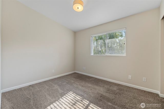 a view of wooden floor and windows in a room