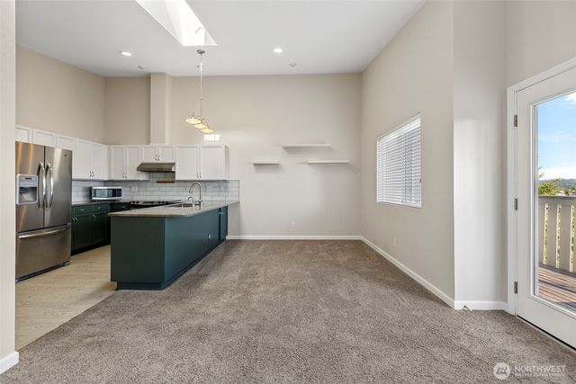 a view of a kitchen with a sink cabinets and a window