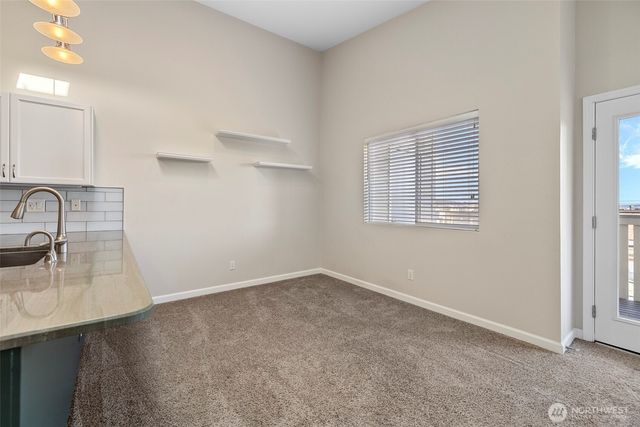 a kitchen with cabinets and stainless steel appliances