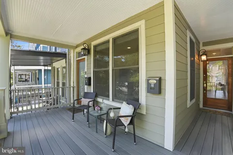 a balcony with table and chairs