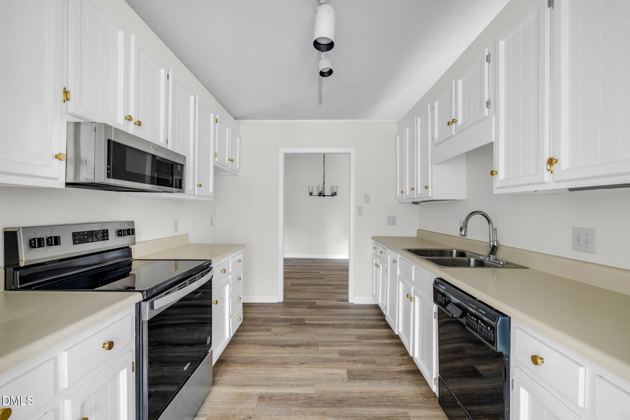 2860 Rue Sans Famille Raleigh, NC 27607 - Photo 11 of 40 a kitchen with stainless steel appliances granite countertop a stove and a sink