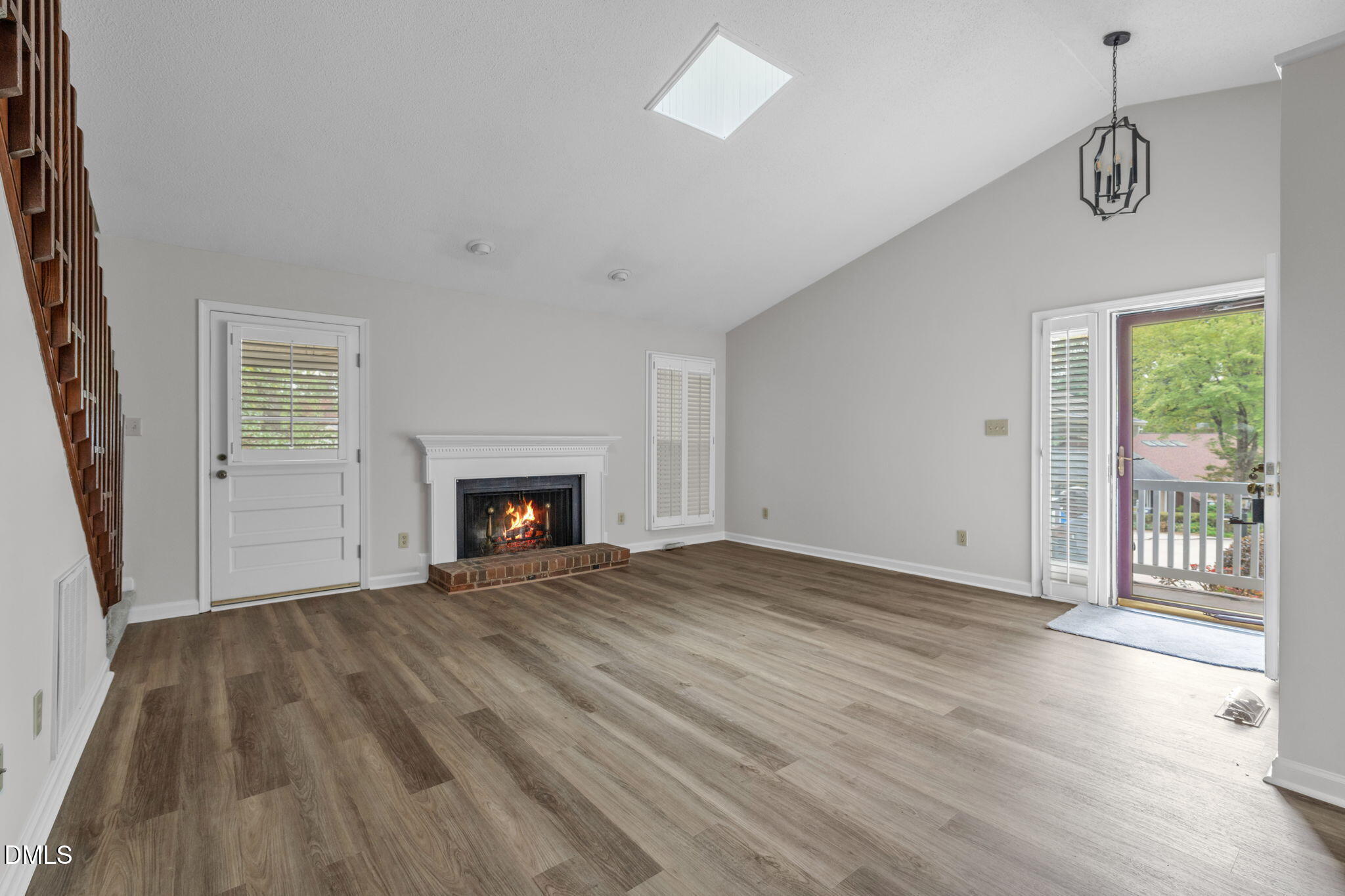 2860 Rue Sans Famille Raleigh, NC 27607 - Photo 5 of 40 a view of an empty room with wooden floor fireplace and a window