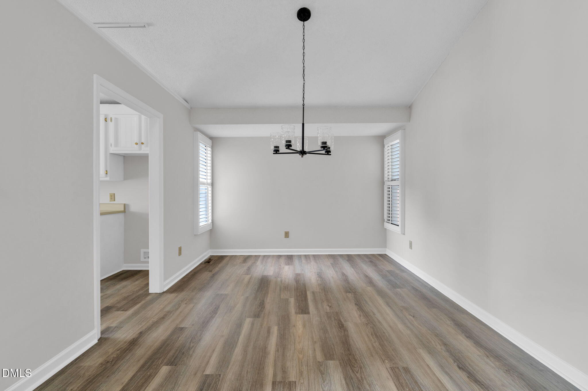 2860 Rue Sans Famille Raleigh, NC 27607 - Photo 8 of 40 a view of a room with wooden floor and ceiling fan