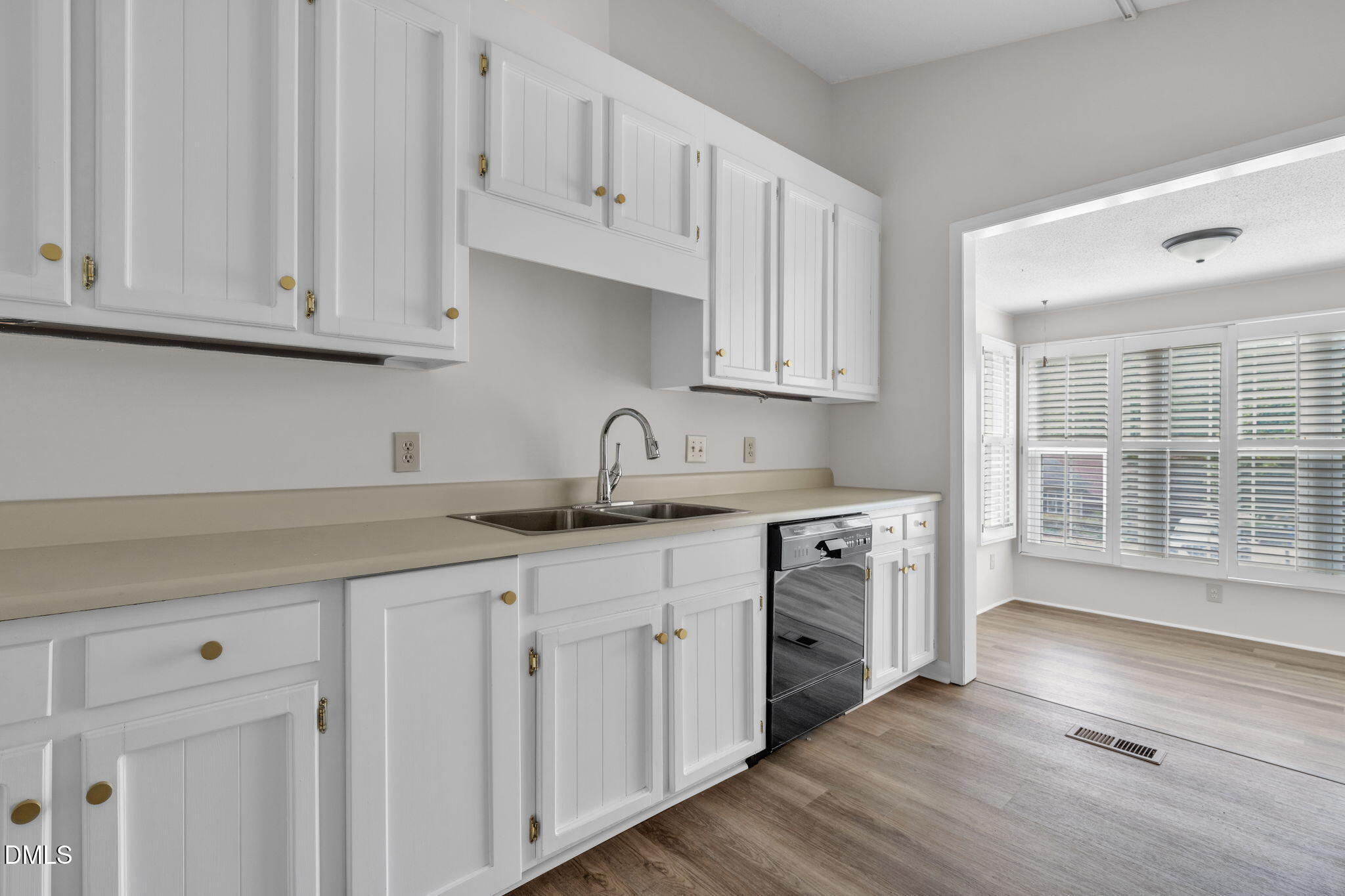 2860 Rue Sans Famille Raleigh, NC 27607 - Photo 10 of 40 a kitchen with granite countertop white cabinets and a hard wood floors