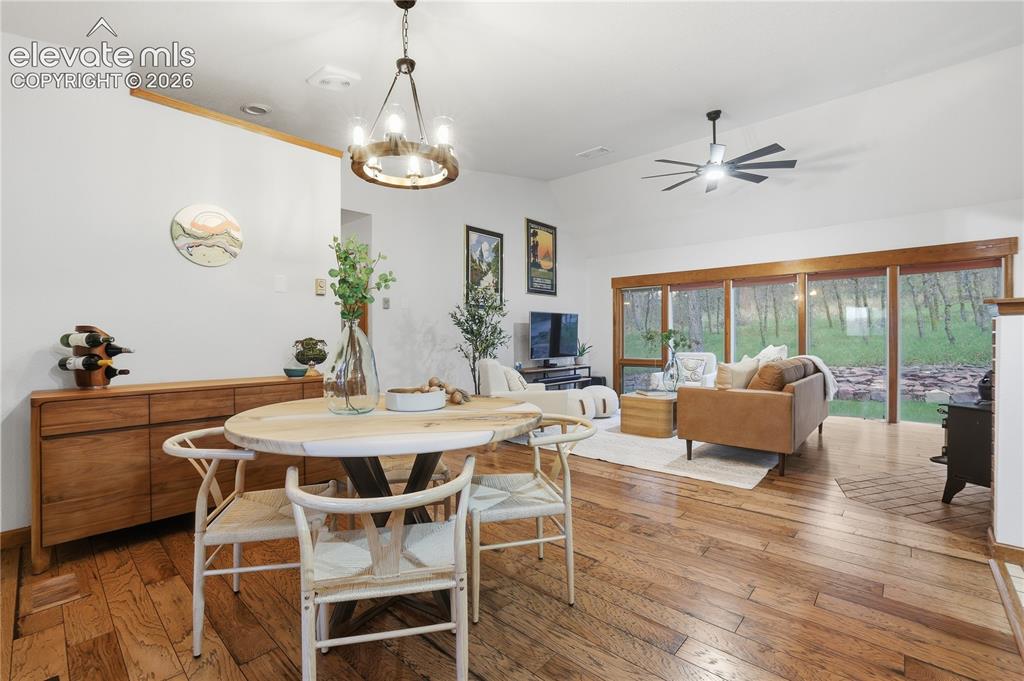 18190 Forest View Road Monument, CO 80132 - Photo 13 of 50 a view of a dining room with furniture wooden floor and chandelier