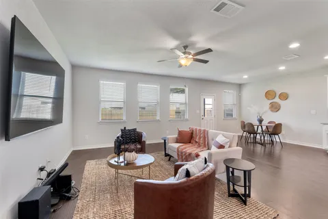 a living room with furniture and wooden floor