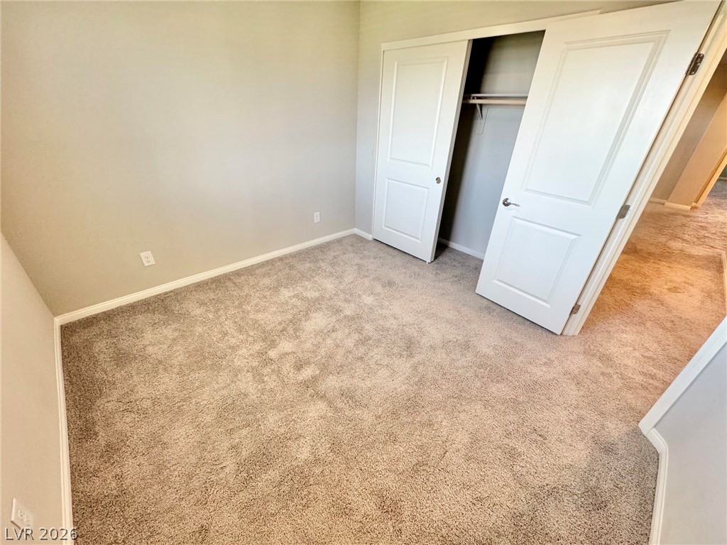 7020 Colonial Ranch Street Las Vegas, NV 89166 - Photo 29 of 37 Soft carpeting underfoot defines this versatile bedroom complete with a built-in closet.