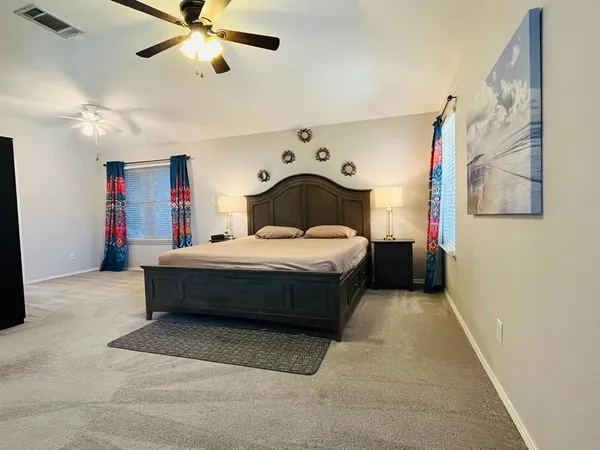 a view of a livingroom with furniture and a ceiling fan