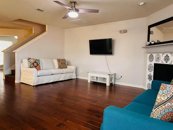 a view of empty room with wooden floor and window