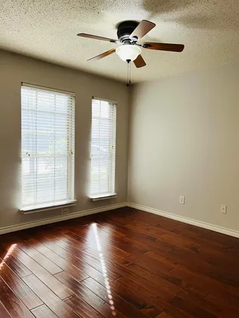 a bedroom with a large bed and a ceiling fan