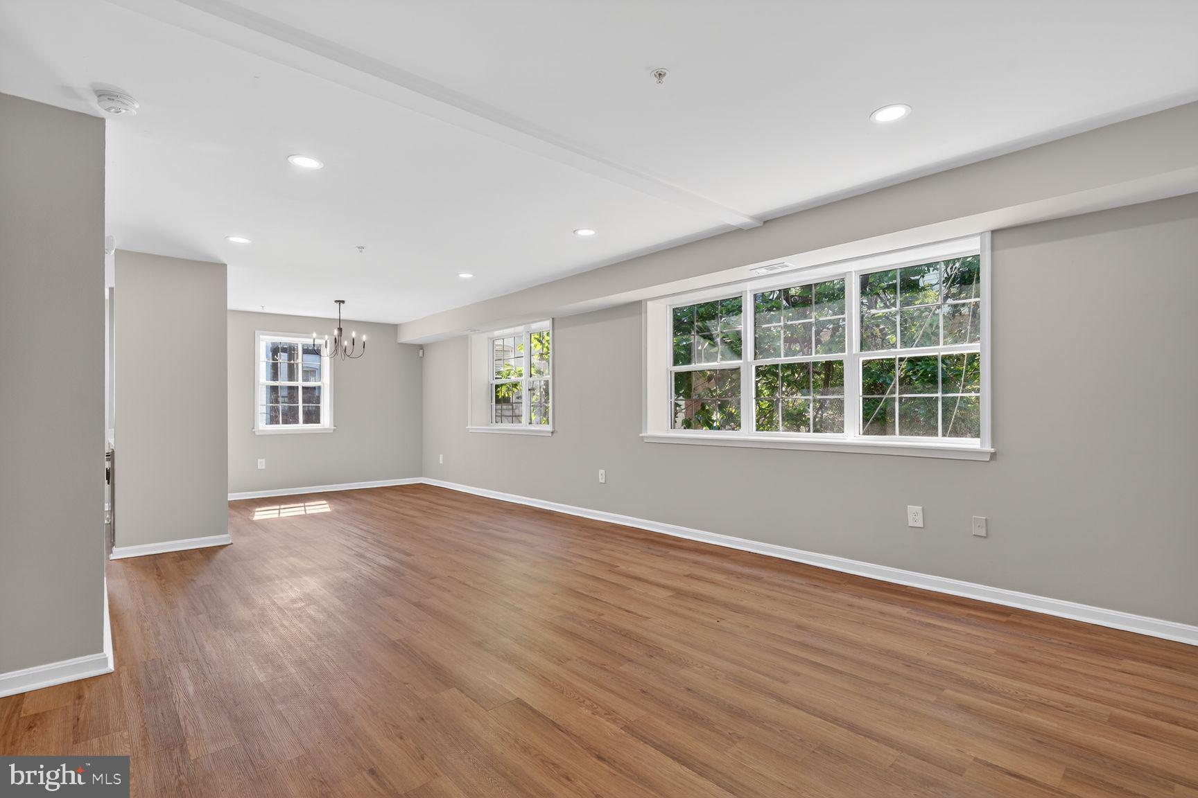 1008 Rittenhouse Street Northwest, Unit 15 Washington, DC 20011 - Photo 2 of 39 an empty room with wooden floor and windows