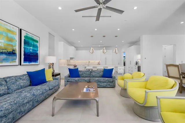 a living room with furniture and a air conditioner vent