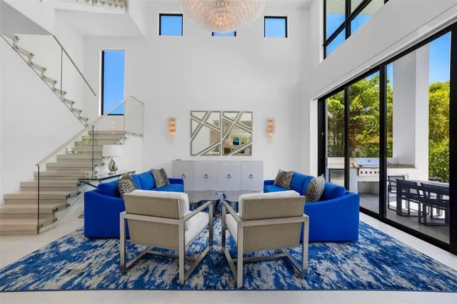 a bedroom with a bed and large windows