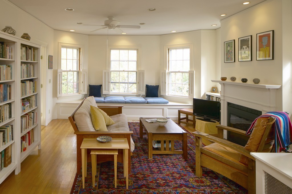 a living room with fireplace furniture and a window