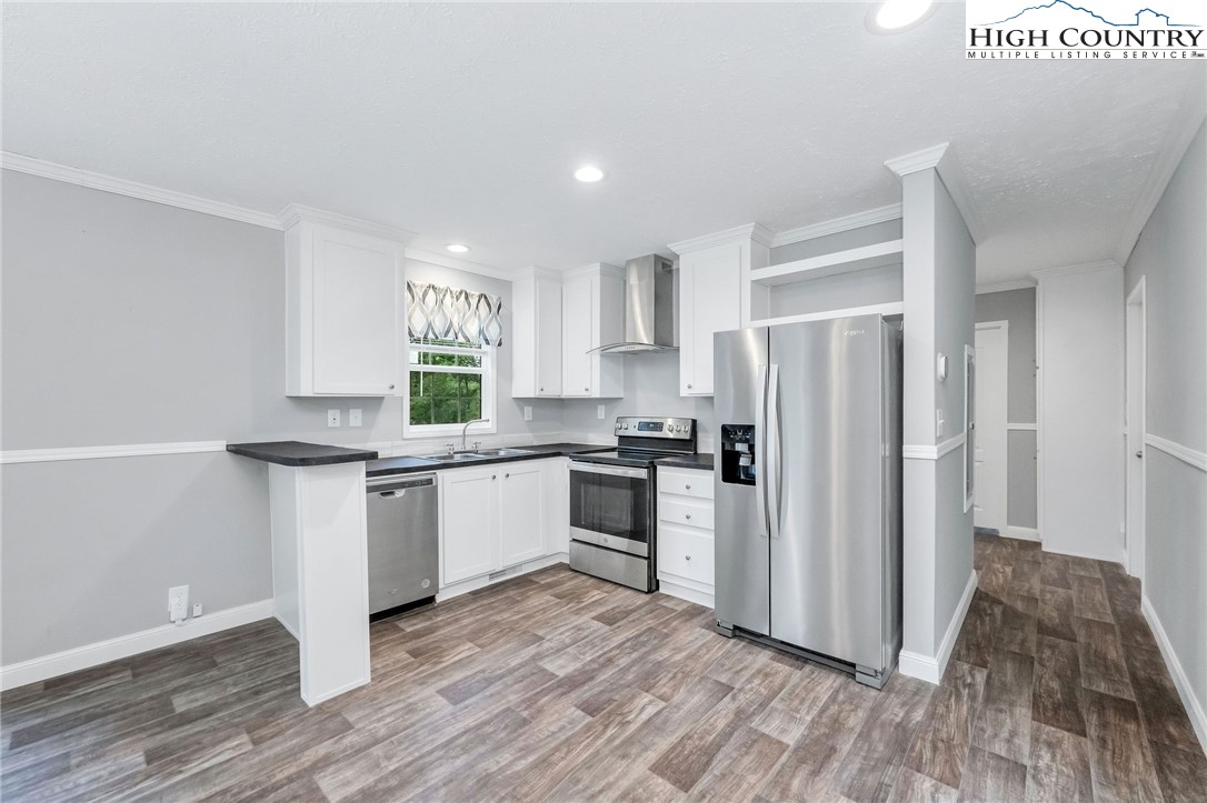 939 Don Bare Road Jefferson, NC 28640 - Photo 13 of 22 a kitchen with a refrigerator and white cabinets