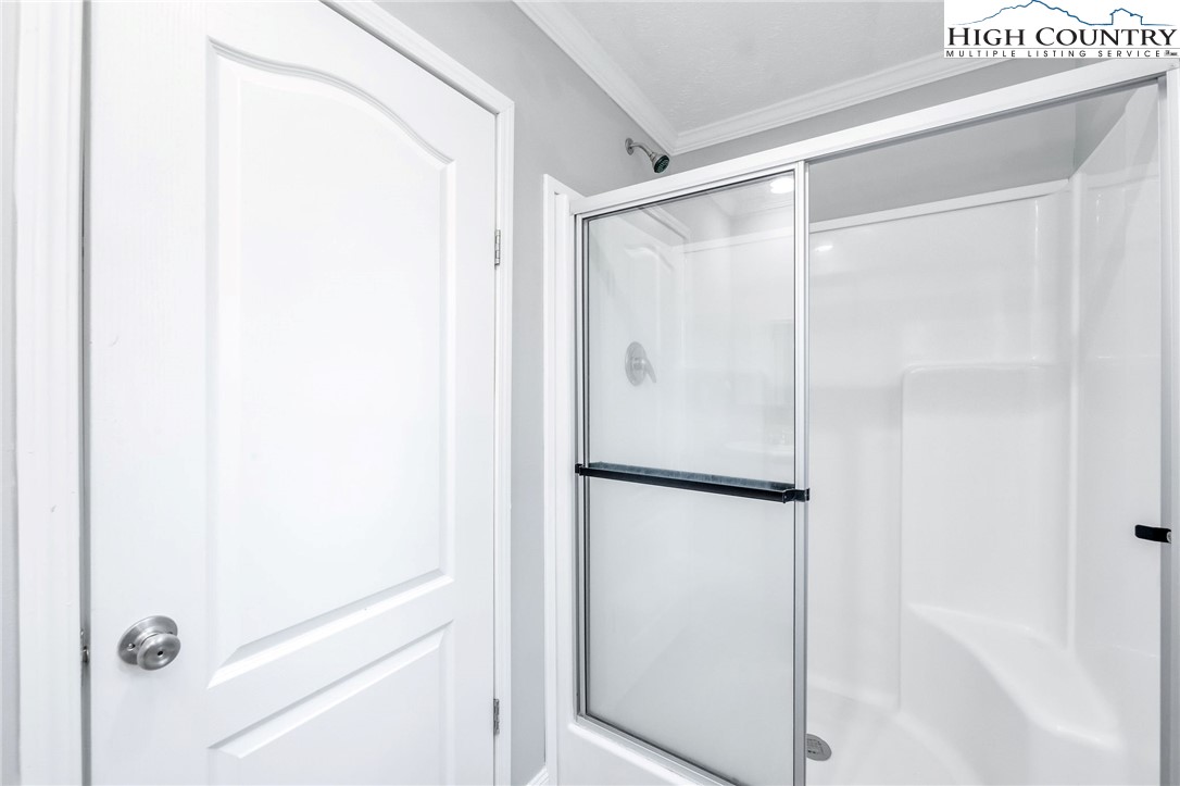 939 Don Bare Road Jefferson, NC 28640 - Photo 18 of 22 a bathroom with a shower and a glass door