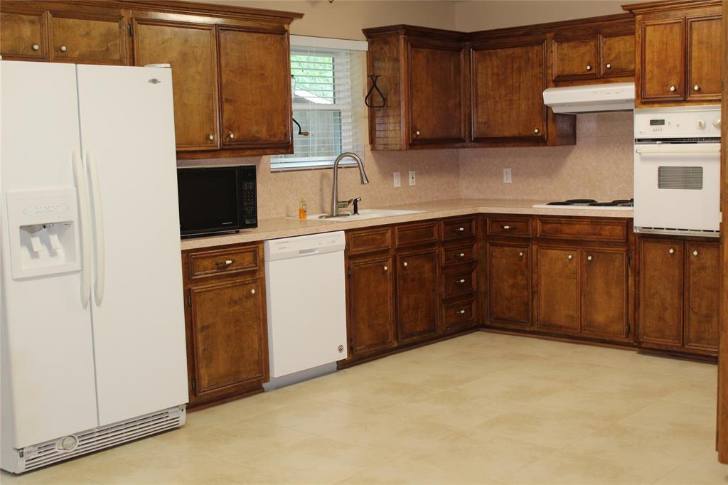 a kitchen with a refrigerator and a sink