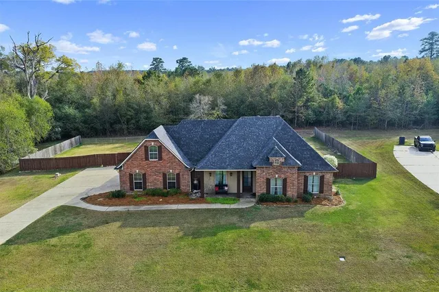 a aerial view of a house with swimming pool and a yard