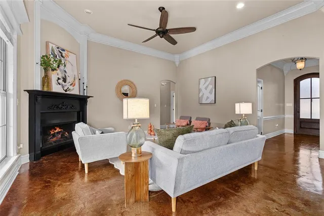 a living room with furniture a fireplace and a table