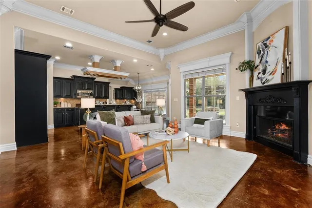 a living room with fireplace furniture and a window
