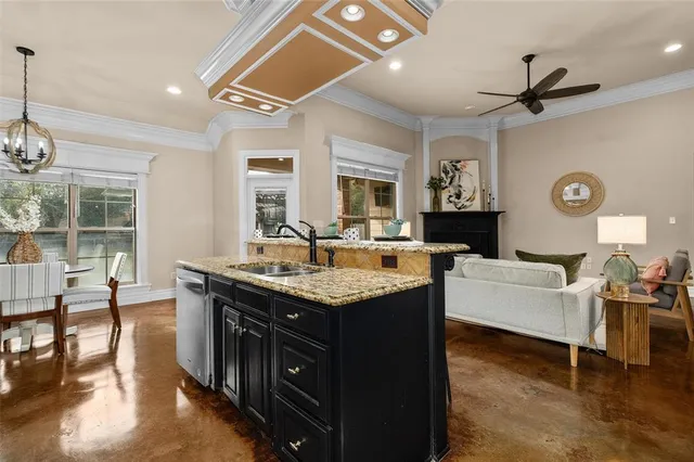 a kitchen with granite countertop a sink and a stove