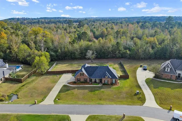a view of a swimming pool with a yard