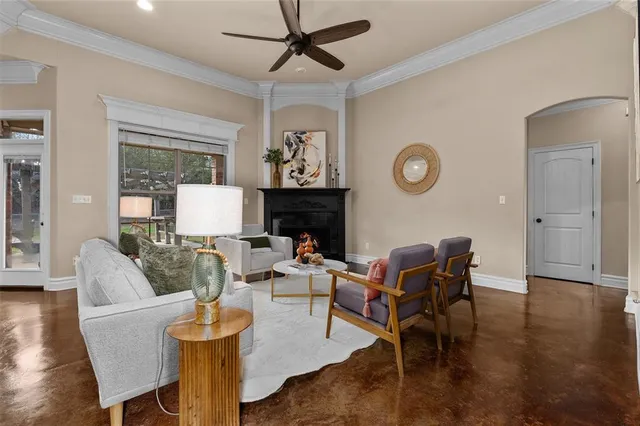 a living room with furniture a rug and a window