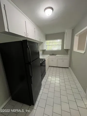 a kitchen with stainless steel appliances a refrigerator and sink
