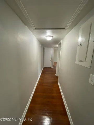 a view of a hallway with wooden floor