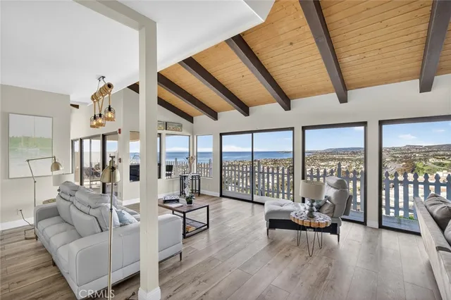 a living room with furniture and a floor to ceiling window