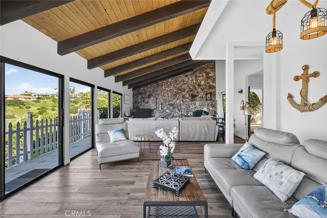 a view of a dining room with furniture large windows and wooden floor