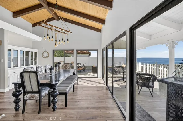 a view of a dining room with furniture large windows and wooden floor