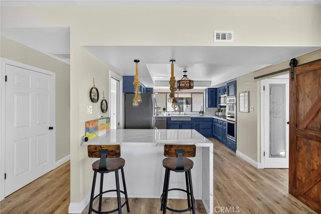 a kitchen with stainless steel appliances granite countertop wooden cabinets and sink