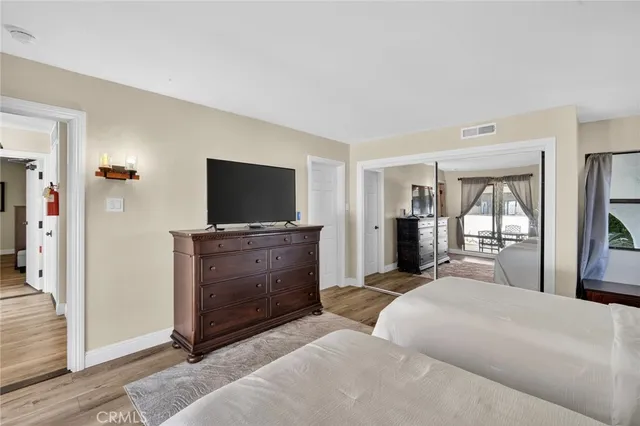 a view of a patio with couches table and chairs with wooden floor and fence