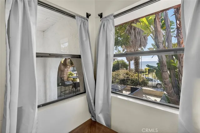 a view of a porch with furniture and a yard