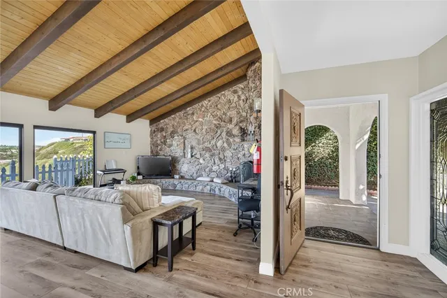 a living room with furniture and a floor to ceiling window