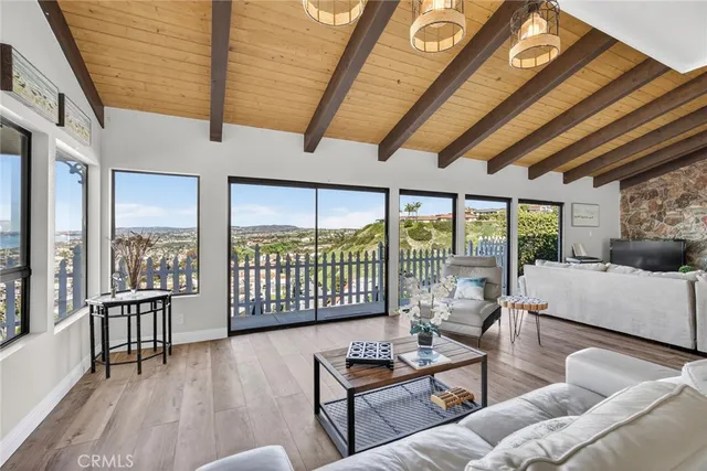 a living room with furniture and a floor to ceiling window