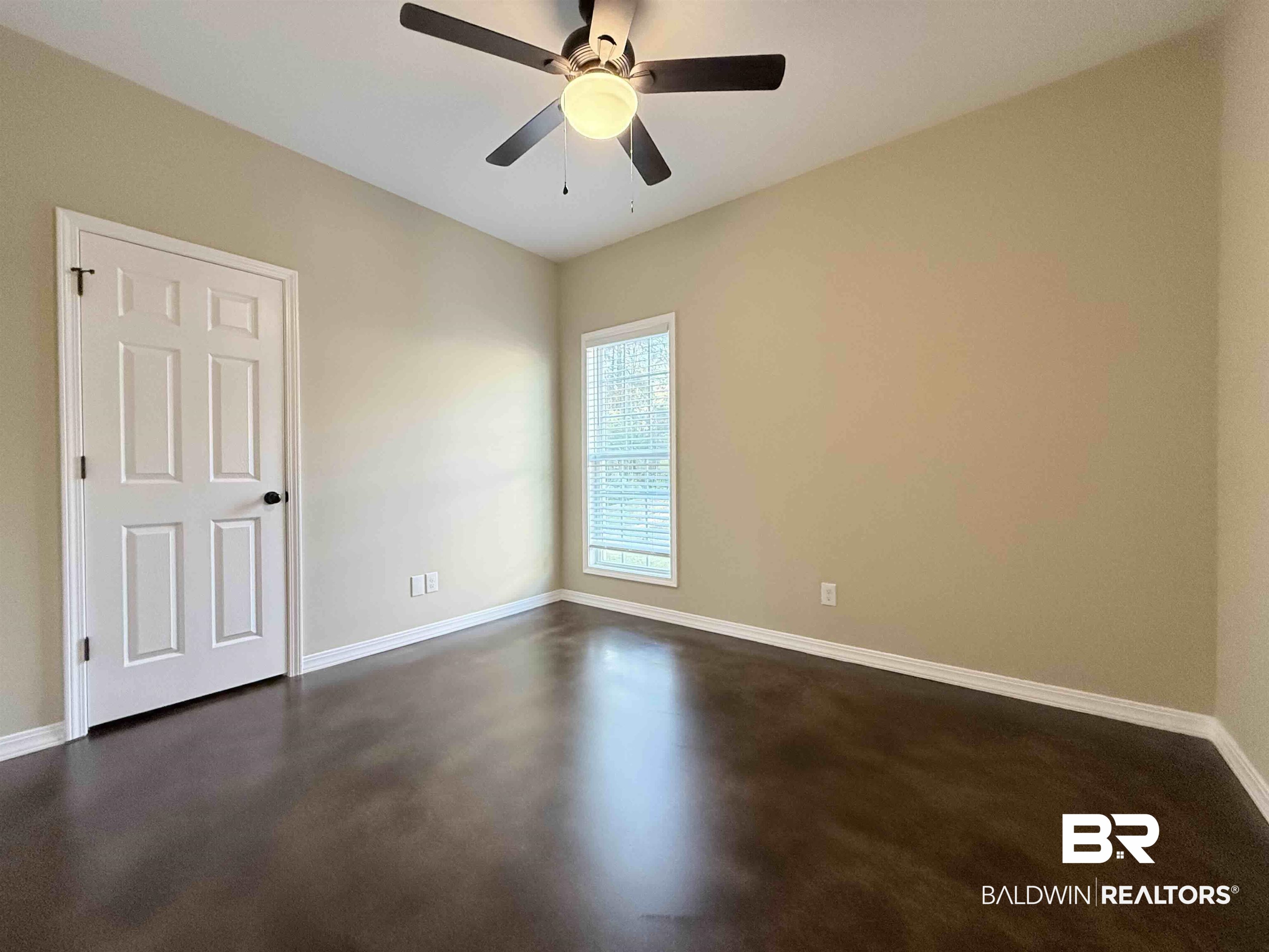 33071 -B Stables Drive, Unit B Daphne, AL 36527 - Photo 6 of 13 Empty room featuring finished concrete floors and ceiling fan