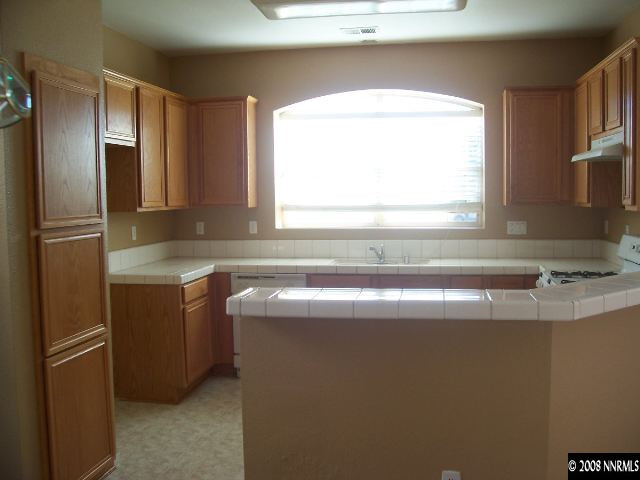 9679 Truckee Meadows Place Reno, NV 89521 - Photo 3 of 9 a view of a kitchen with a sink and a window