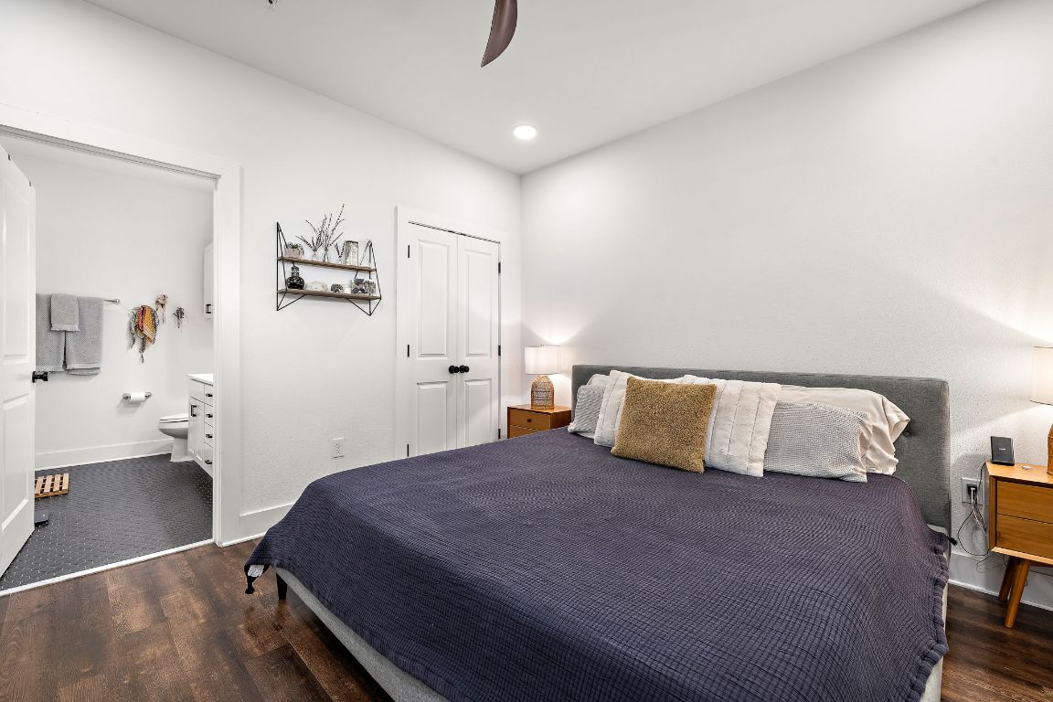4704 Sunset Trail, Unit 1101 Austin, TX 78745 - Photo 13 of 23 Bedroom with dark wood-style floors, recessed lighting, a closet, ensuite bathroom, and a ceiling fan