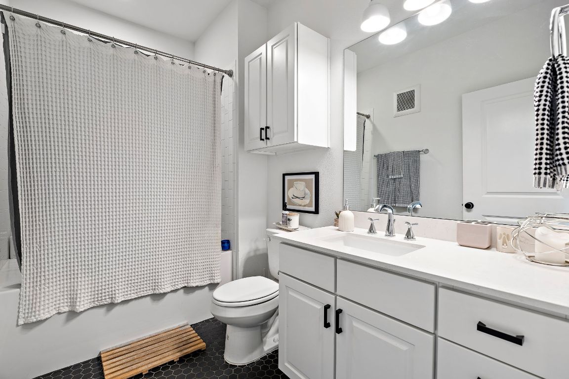4704 Sunset Trail, Unit 1101 Austin, TX 78745 - Photo 17 of 23 Bathroom featuring vanity and shower / tub combo