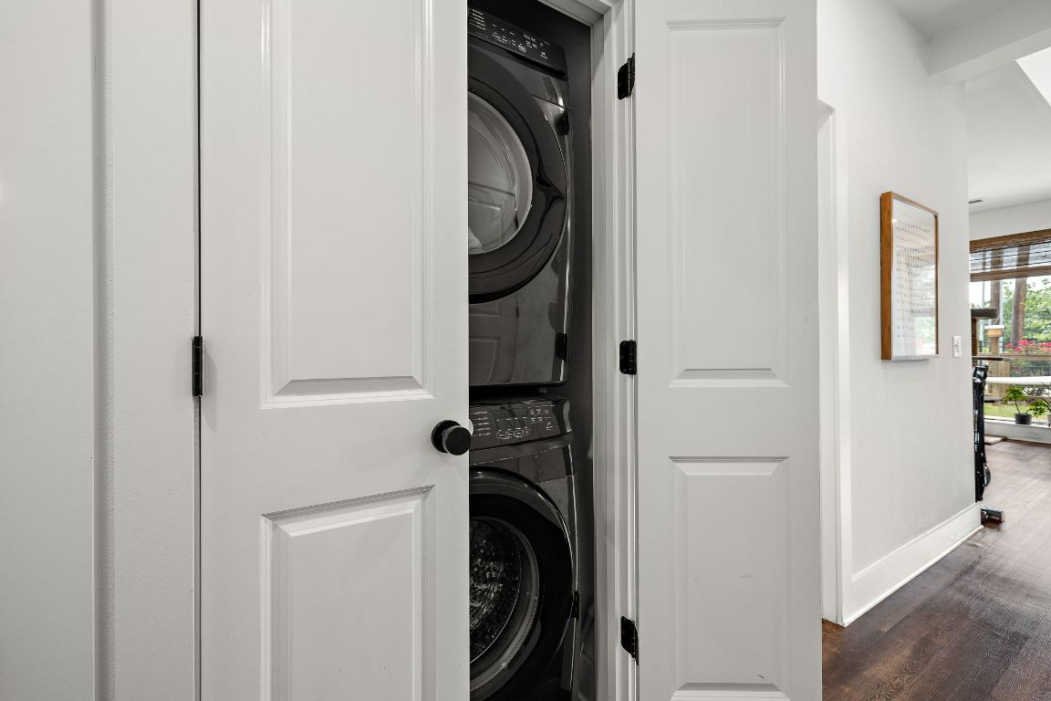 4704 Sunset Trail, Unit 1101 Austin, TX 78745 - Photo 18 of 23 Laundry room with stacked washer / drying machine and dark wood-style floors