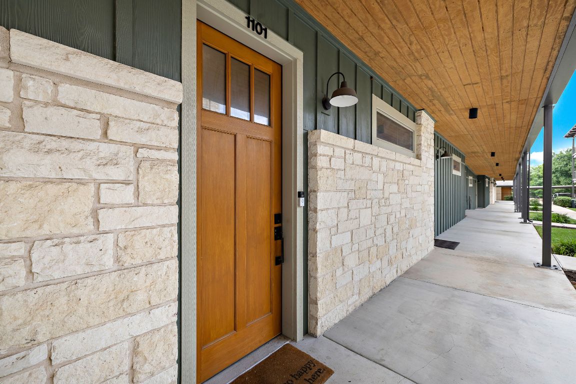 4704 Sunset Trail, Unit 1101 Austin, TX 78745 - Photo 2 of 23 Entrance to property with stone siding and a porch