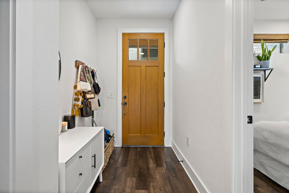 4704 Sunset Trail, Unit 1101 Austin, TX 78745 - Photo 4 of 23 Entrance foyer with dark wood-style flooring and baseboards