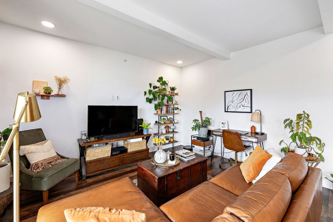 4704 Sunset Trail, Unit 1101 Austin, TX 78745 - Photo 6 of 23 Living room featuring wood finished floors, an office area, beamed ceiling, and recessed lighting