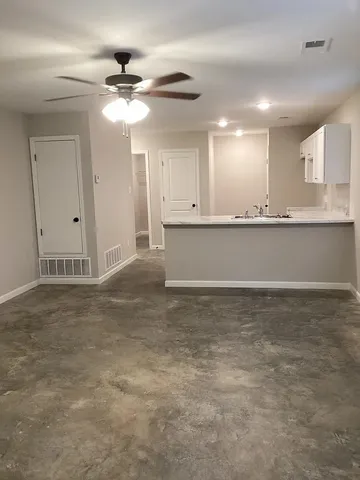a view of a kitchen with a sink and cabinets