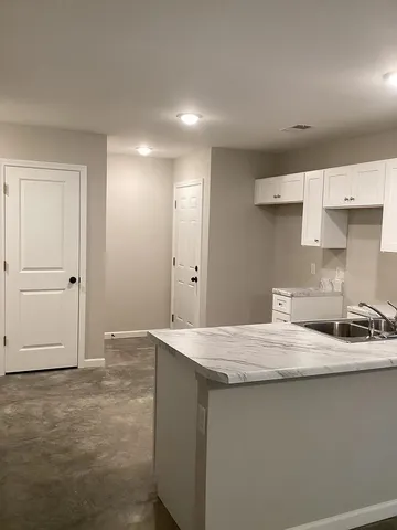 a kitchen with a sink and cabinets